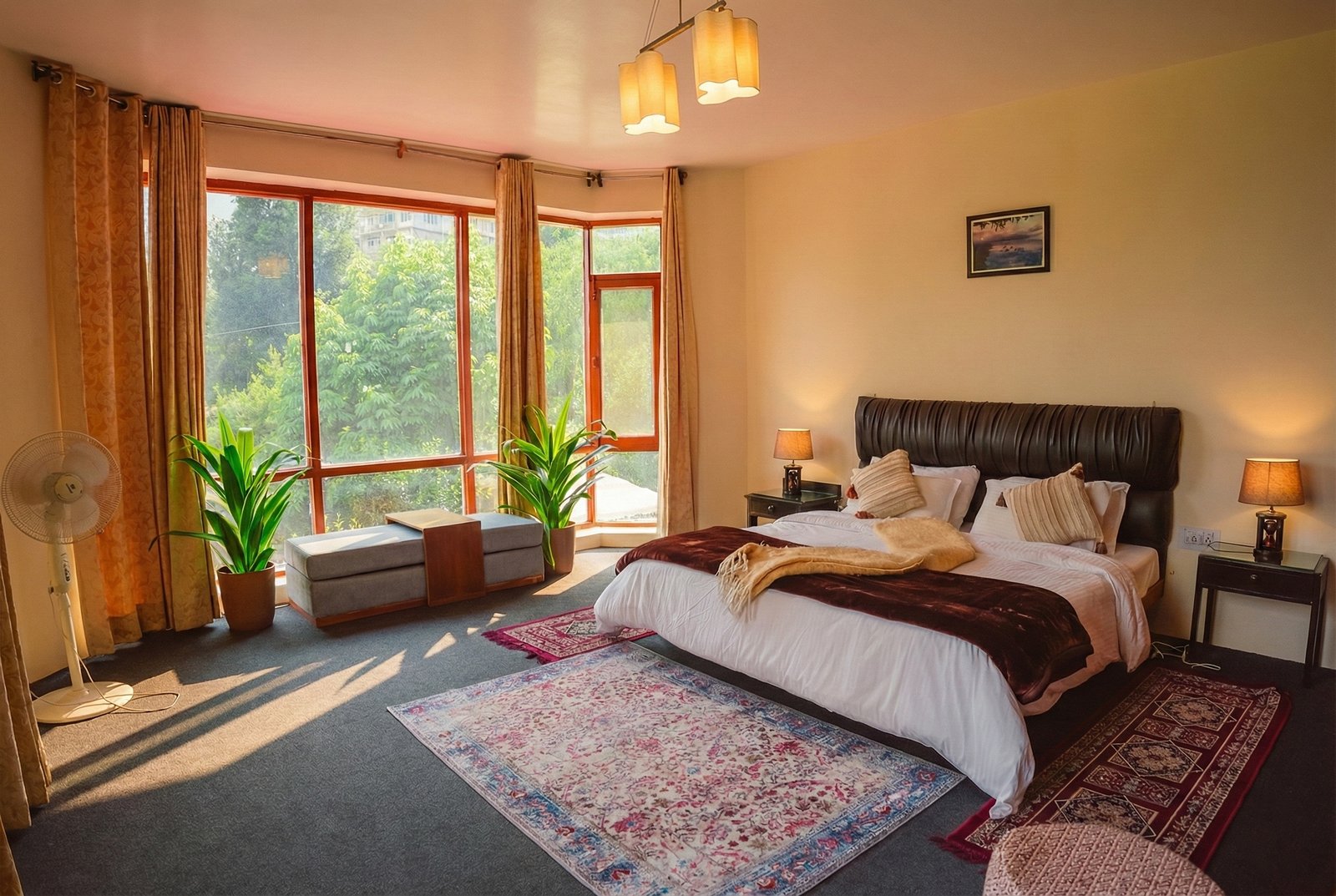 Luxurious master bedroom at Forestbound Cottage Manali with king-size bed, warm wooden decor, and panoramic mountain views through large windows